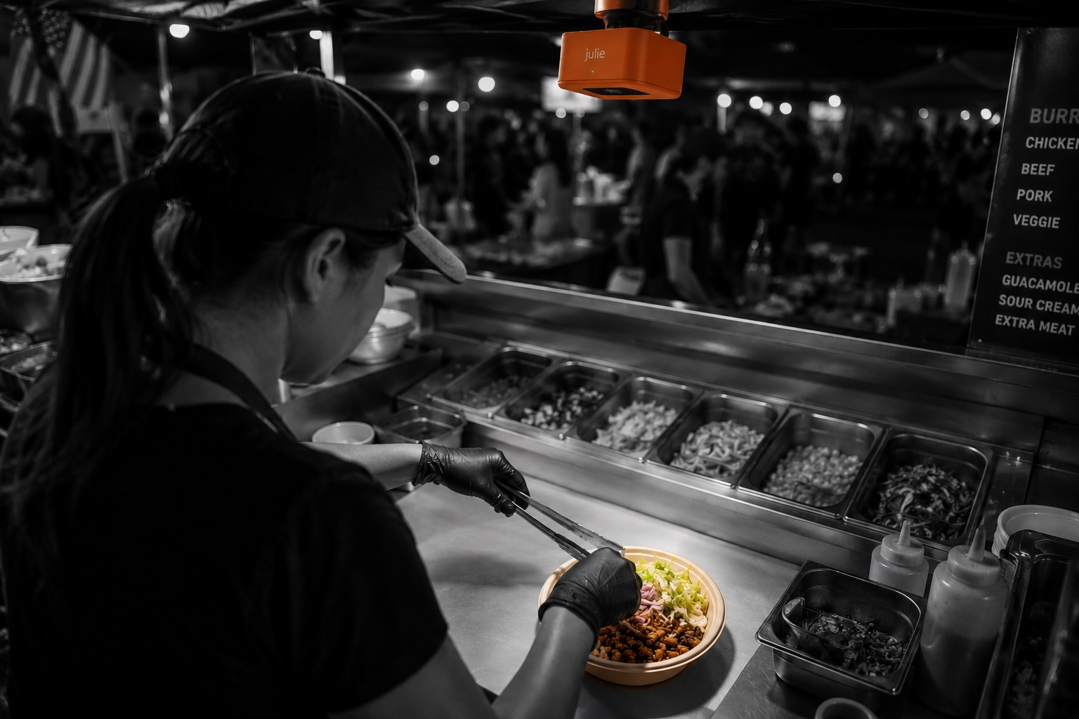 Julie in a food truck, watching the burrito line
